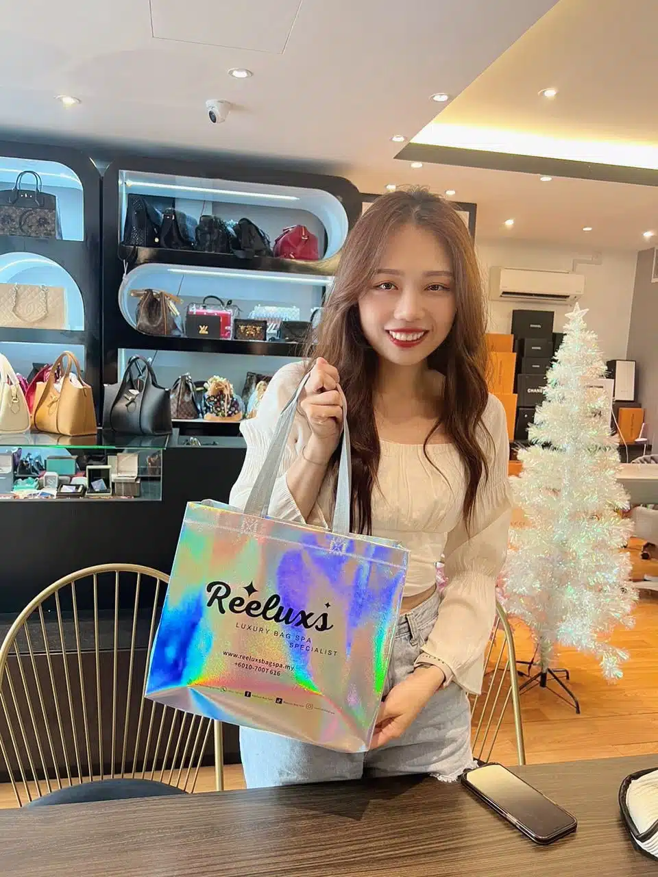 A Reeluxs customer collecting her bag at the outlet