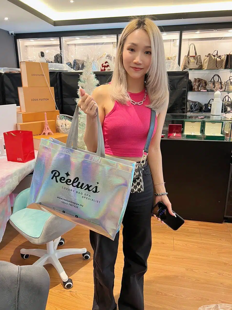A Reeluxs customer collecting her bag at the outlet