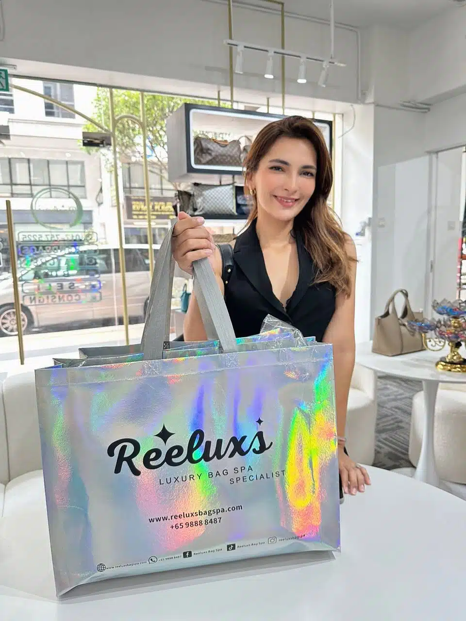 A Reeluxs customer collecting her bag at the outlet