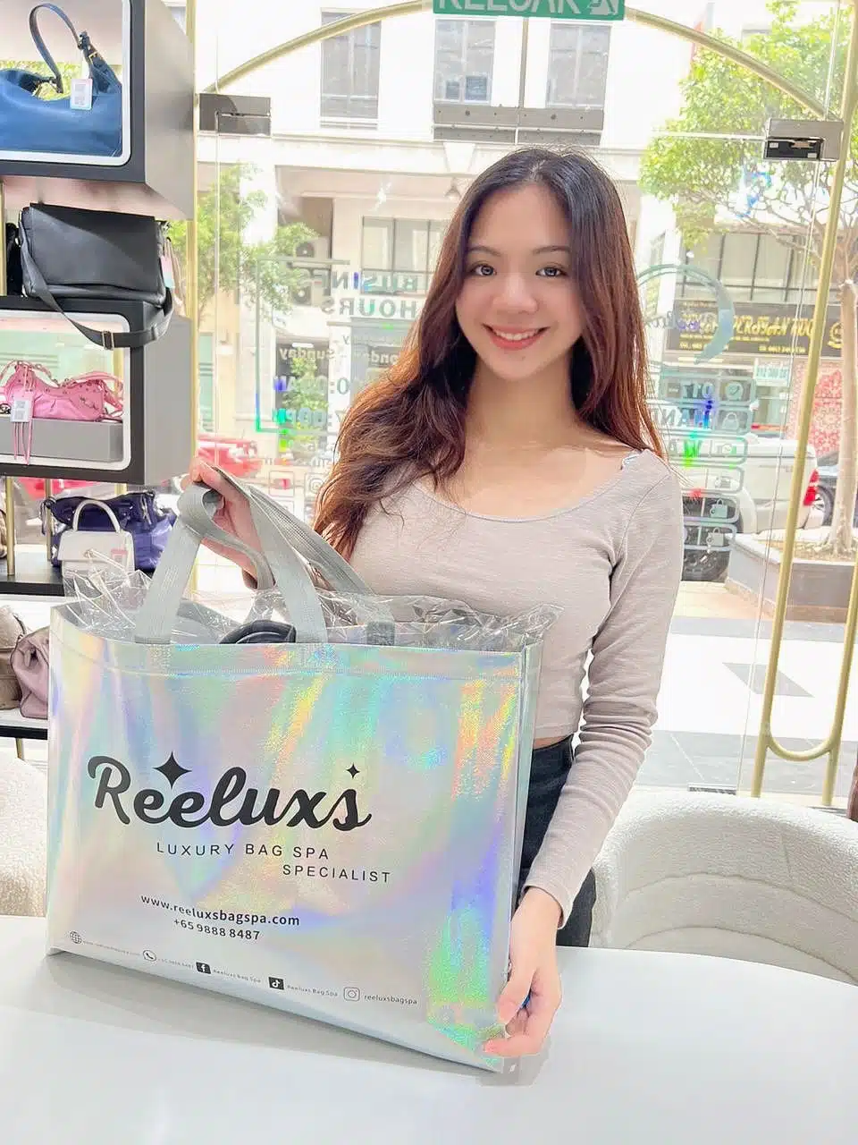 A Reeluxs customer collecting her bag at the outlet
