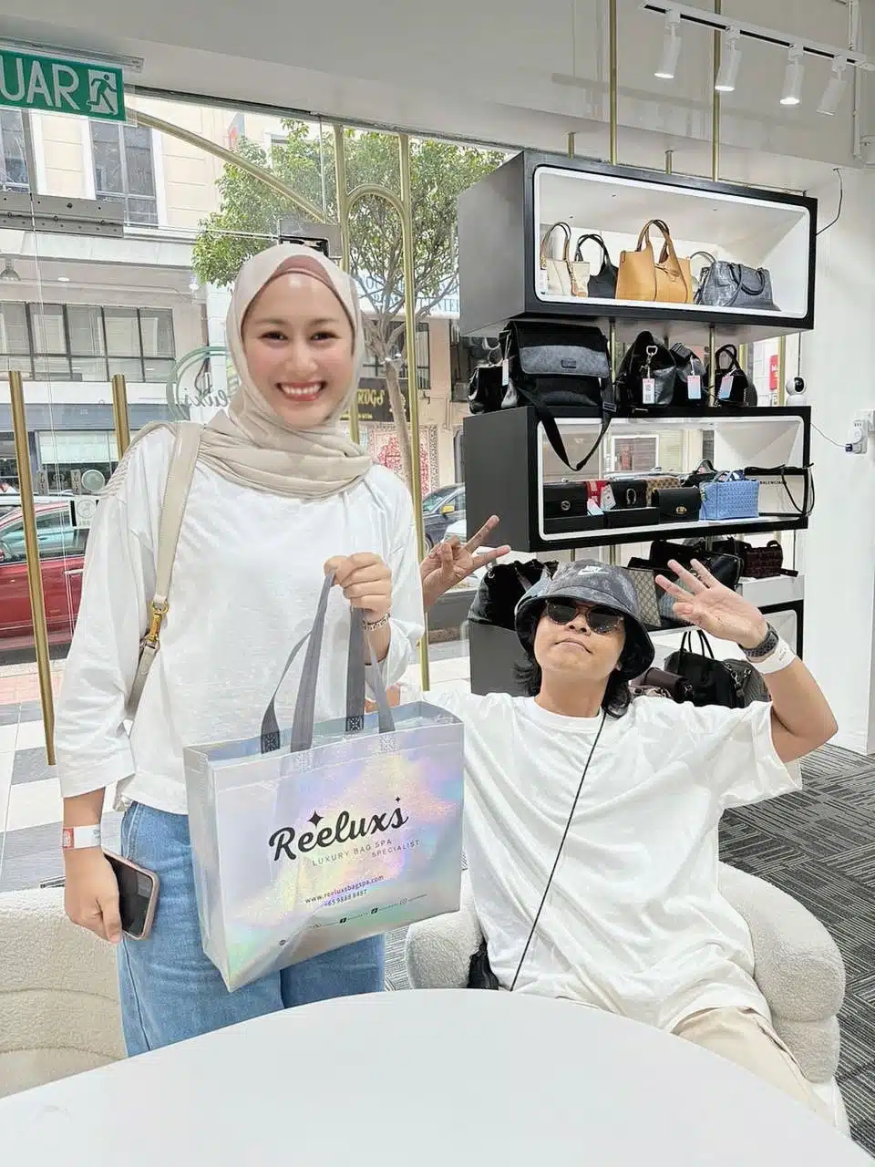A Reeluxs customer collecting her bag at the outlet