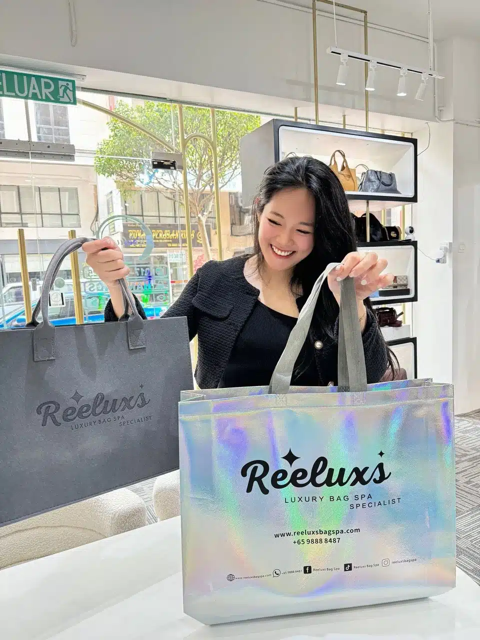 A Reeluxs customer collecting her bag at the outlet