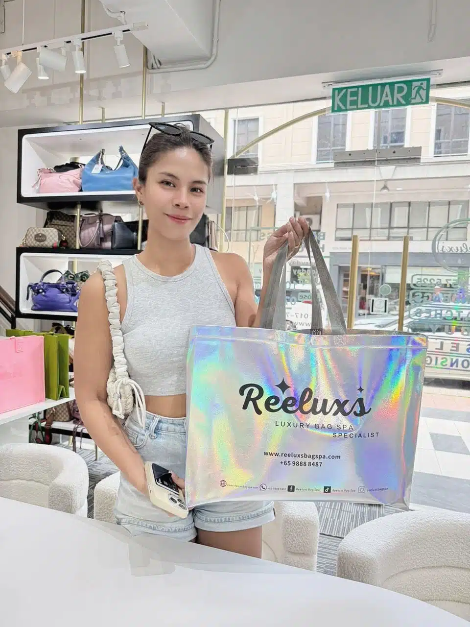 A Reeluxs customer collecting her bag at the outlet