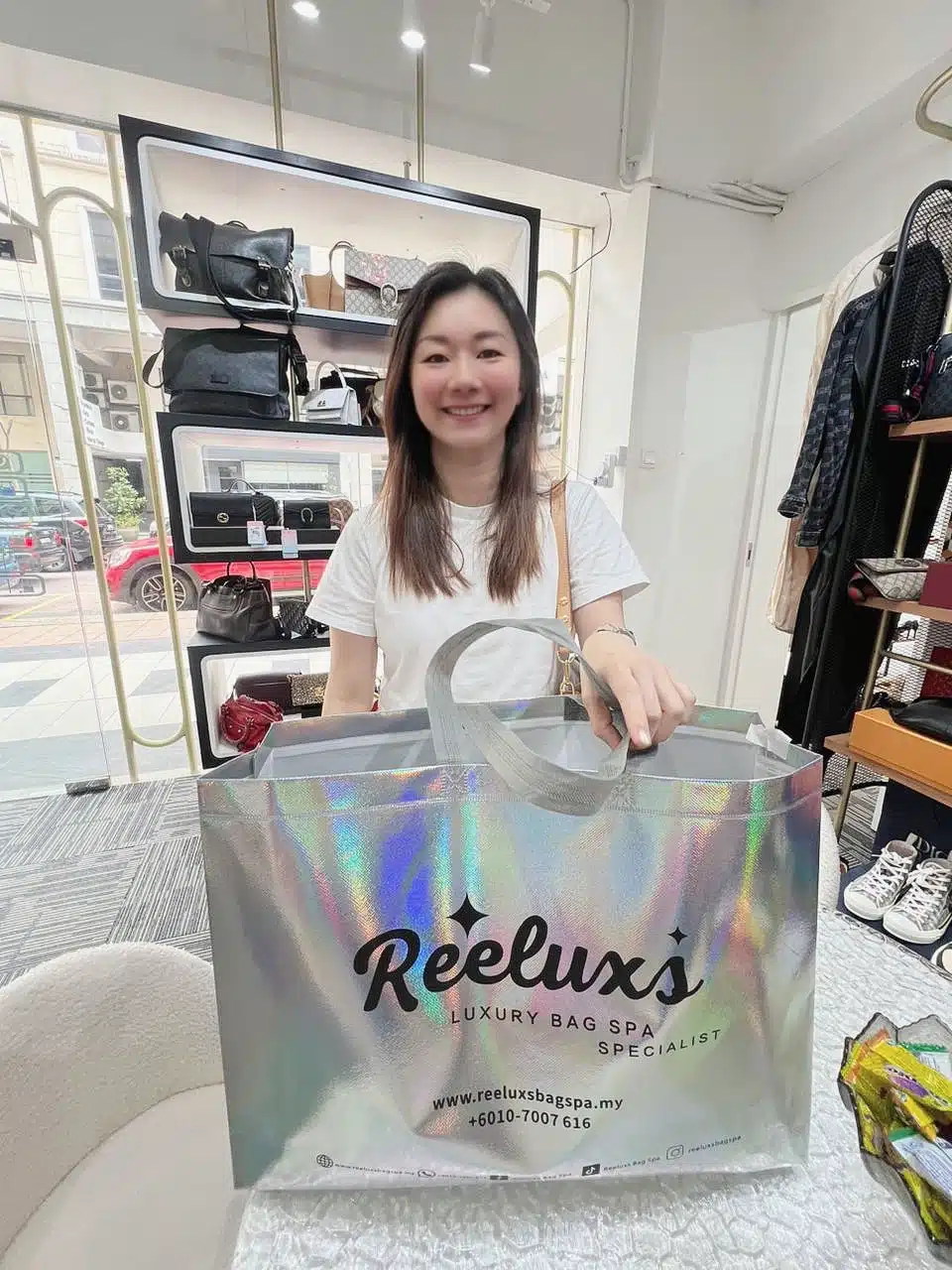 A Reeluxs customer collecting her bag at the outlet