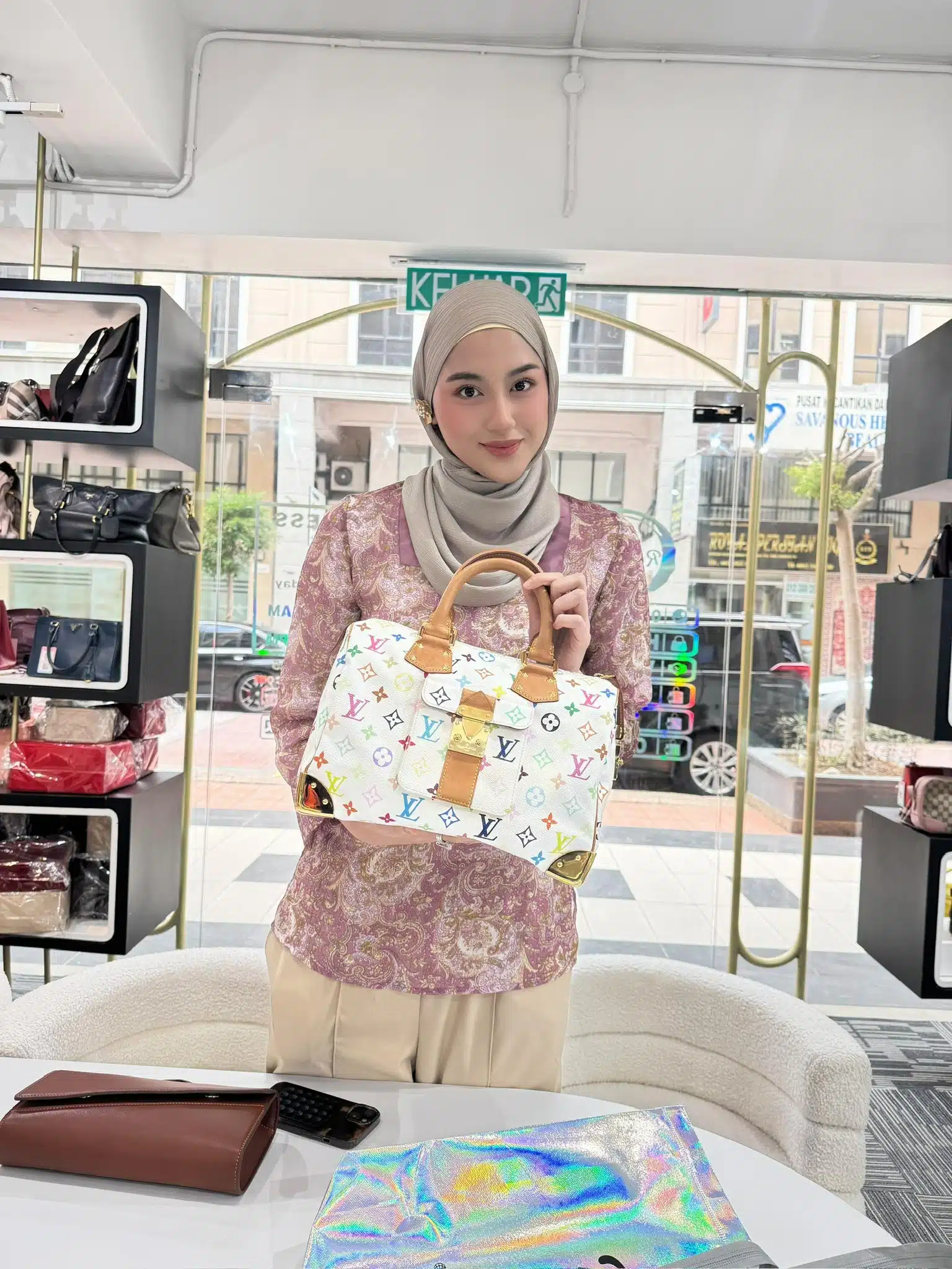 A Reeluxs customer collecting her bag at the outlet