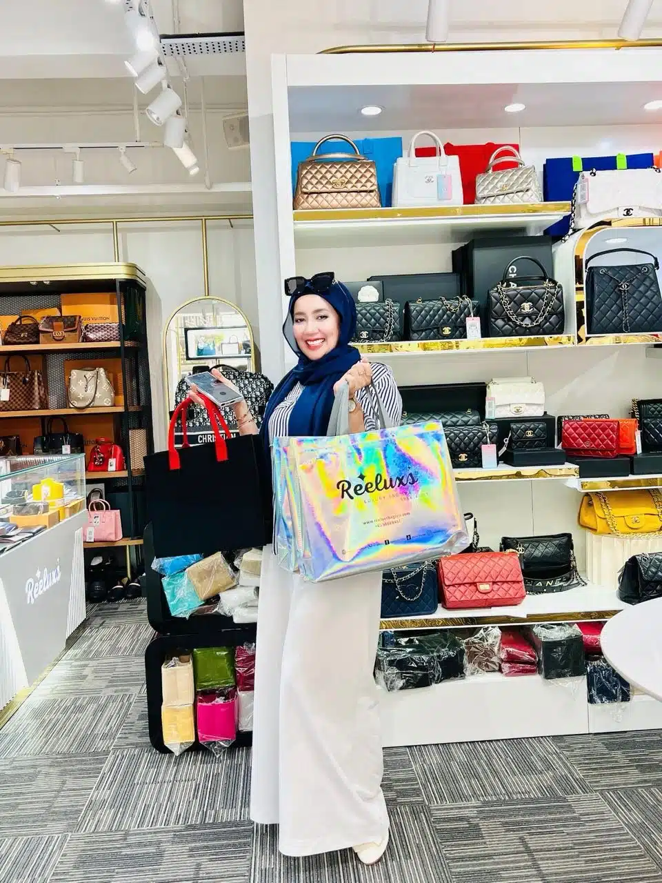 A Reeluxs customer collecting her bag at the outlet