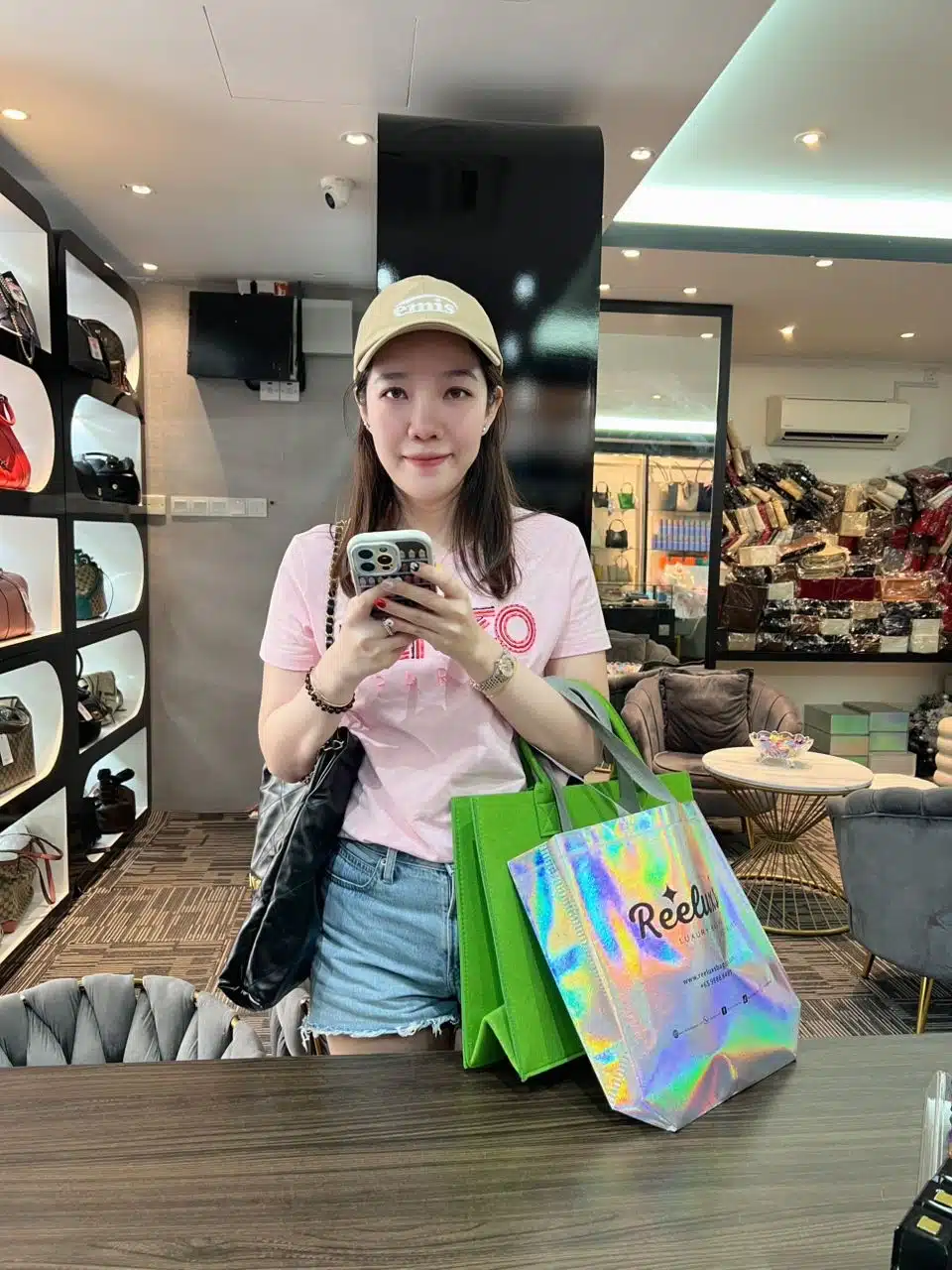 A Reeluxs customer collecting her bag at the outlet