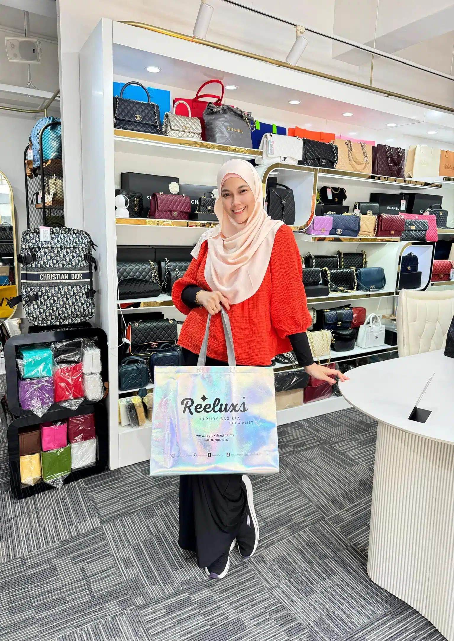 A Reeluxs customer collecting her bag at the outlet