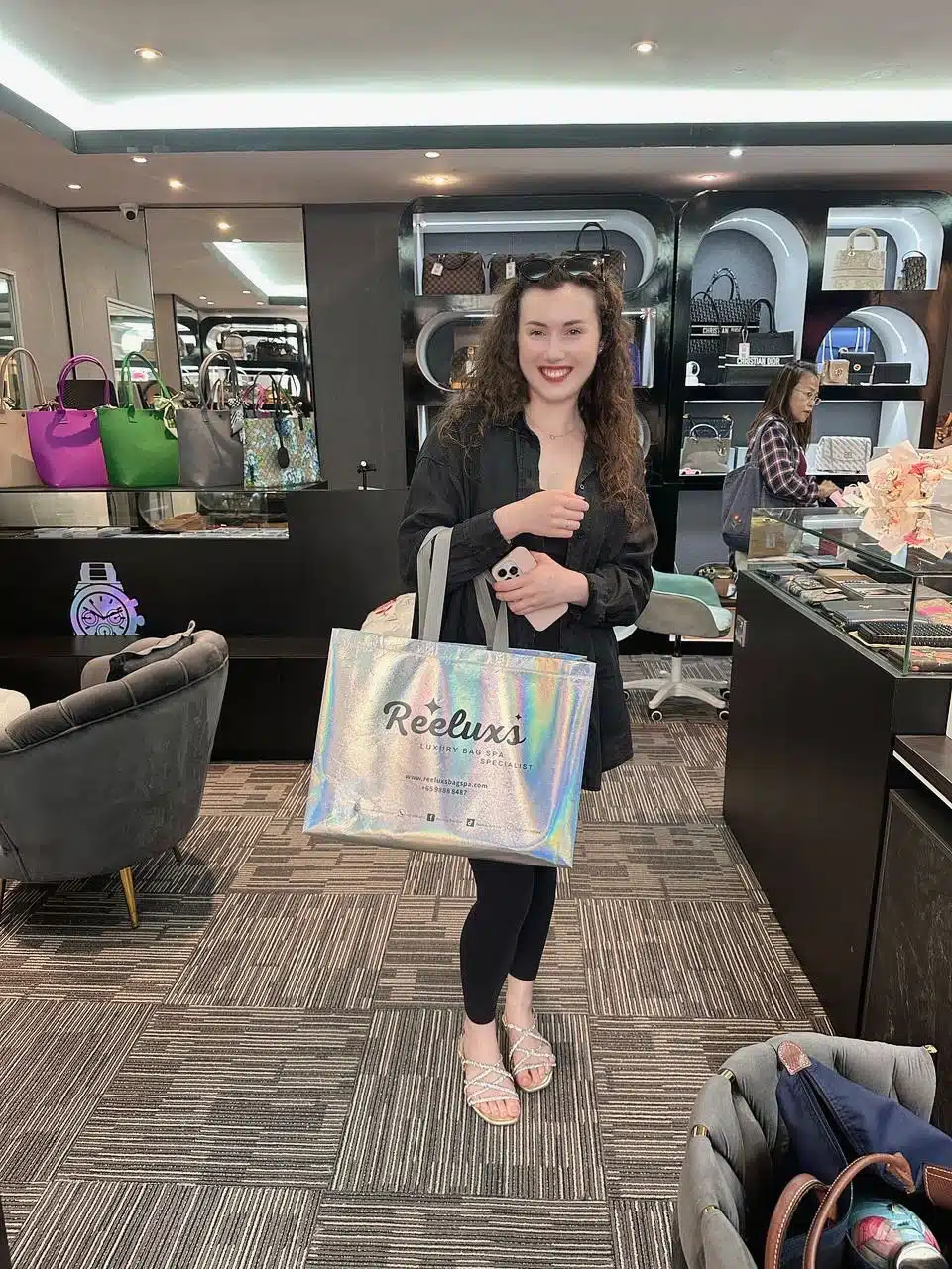 A Reeluxs customer collecting her bag at the outlet