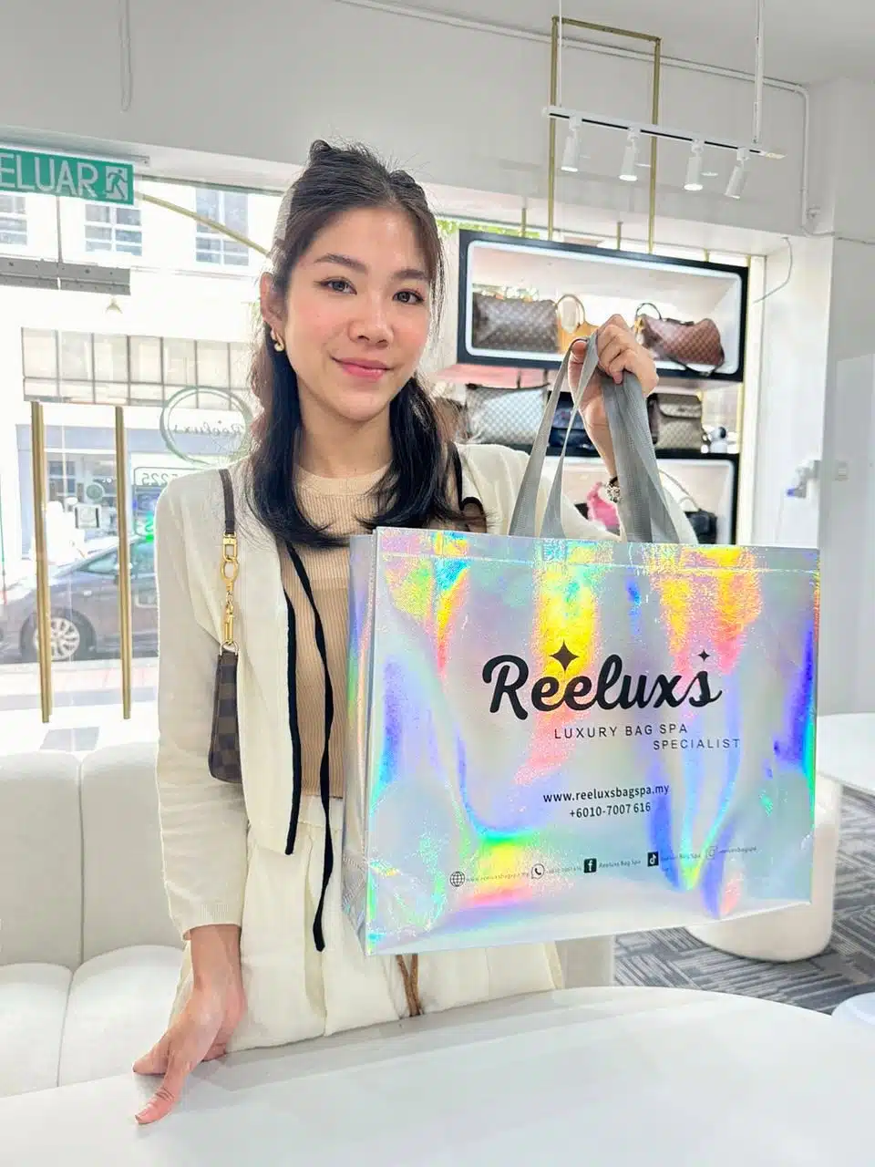 A Reeluxs customer collecting her bag at the outlet